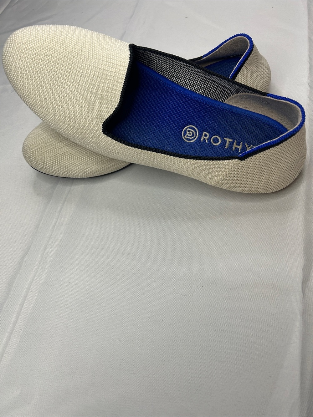 Rothy's Cream Knit Slip-Ons with Bright Blue Lining